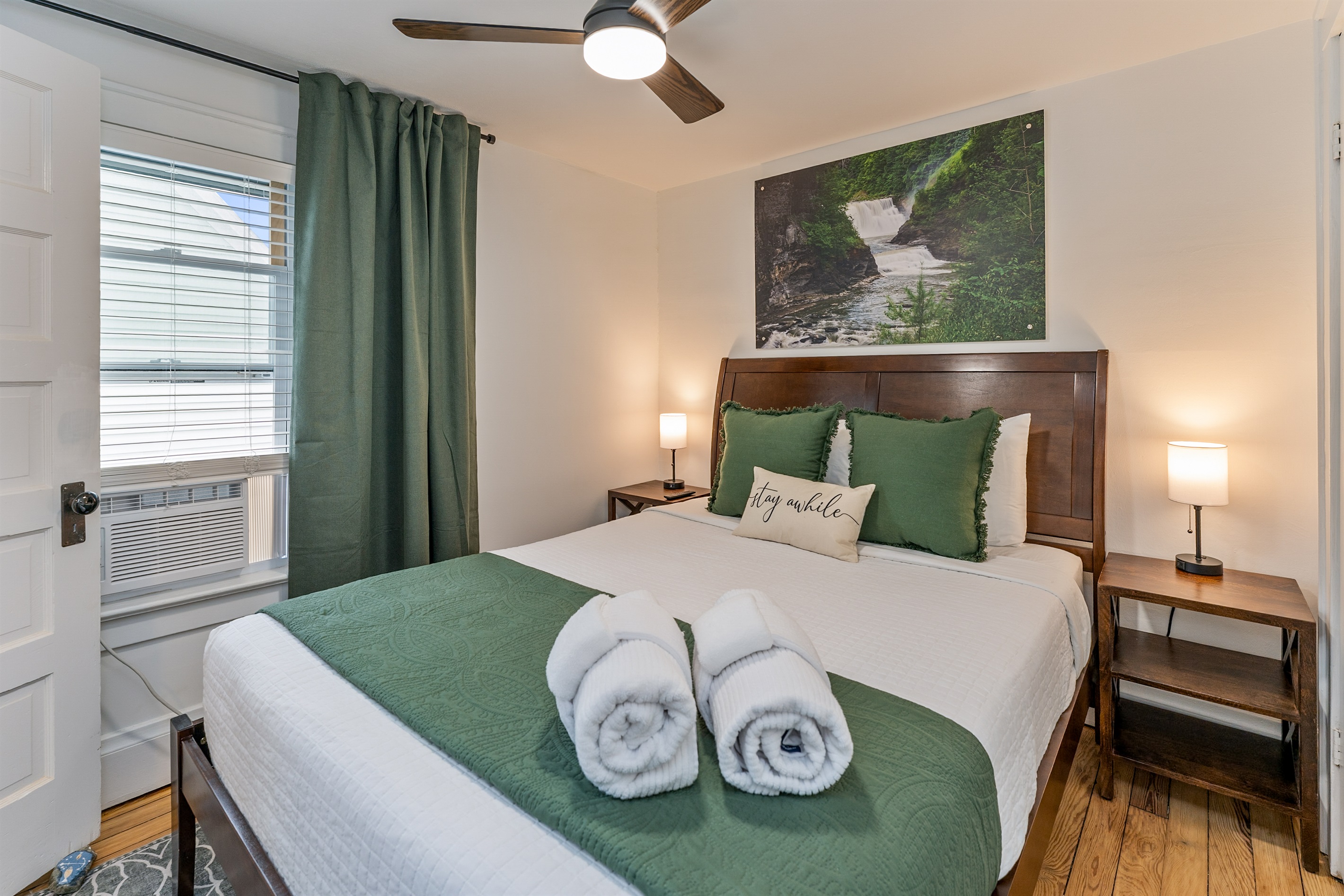 Tranquil queen bedroom retreat with nature-inspired decor, plush bedding, and soothing green accents—unwind and stay awhile! Bedroom #3