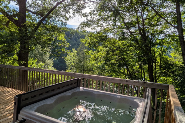 Hot tub with view of Lac McArthur from cottage balcony