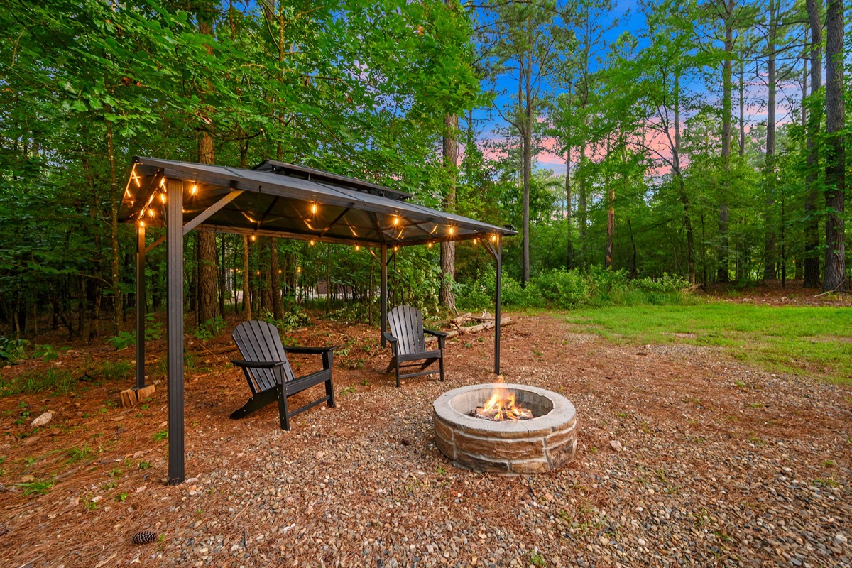 Outdoor Fire Pit Retreat: Gather around the fire under twinkling lights in the serene woods!