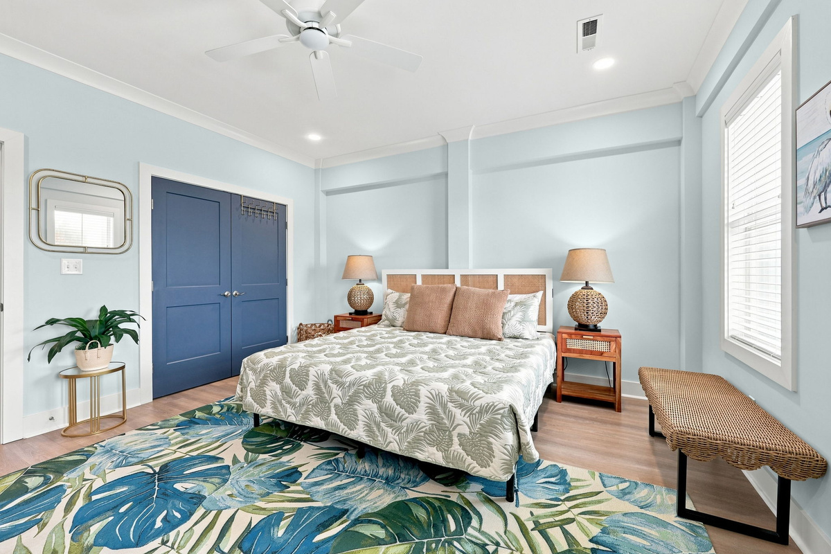 Ground floor king suite featuring a spacious king bed, coastal-inspired decor, and a bright relaxing atmosphere