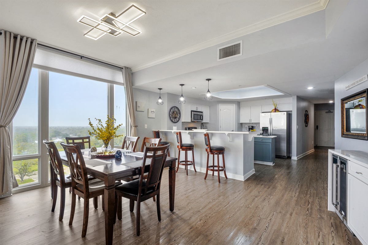 Dining and kitchen; additional folding table and chairs in the closet. NOT PICTURED: dining table has been replaced by an oversized double sized table.