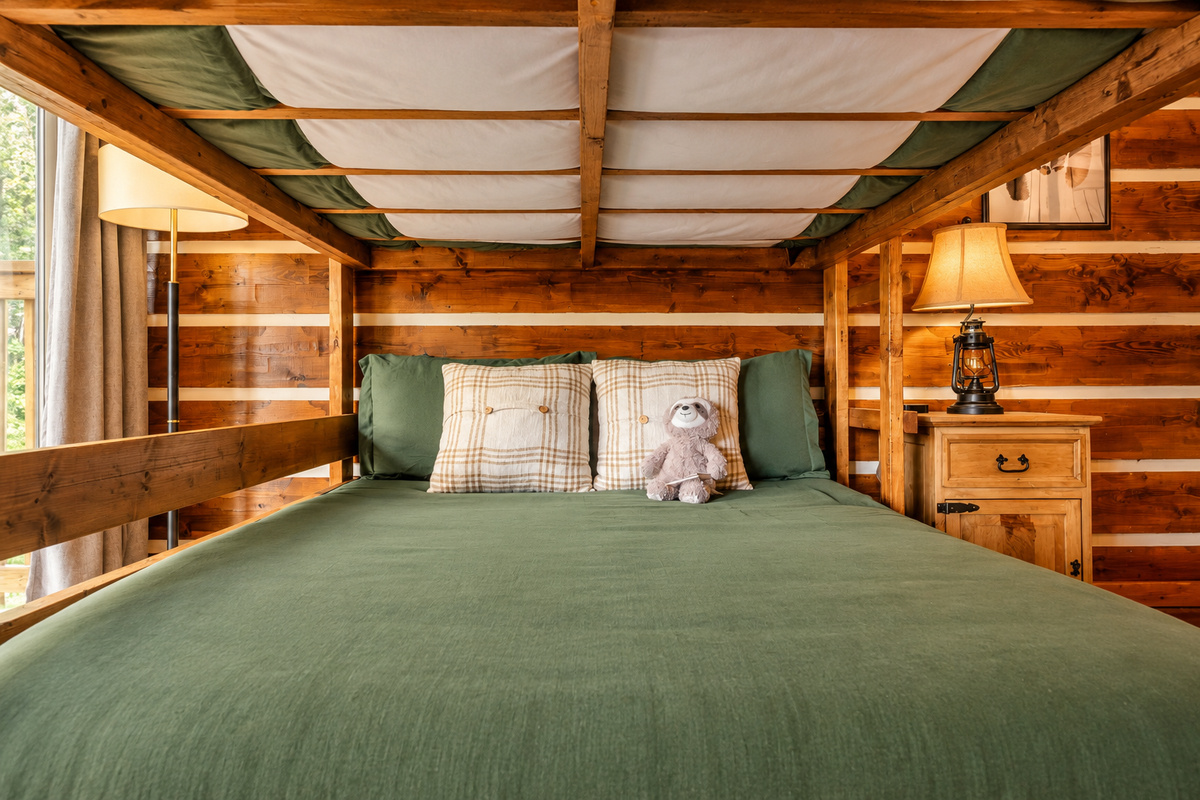 Claim the lower bunk and read by lantern light with a plush sloth sidekick.