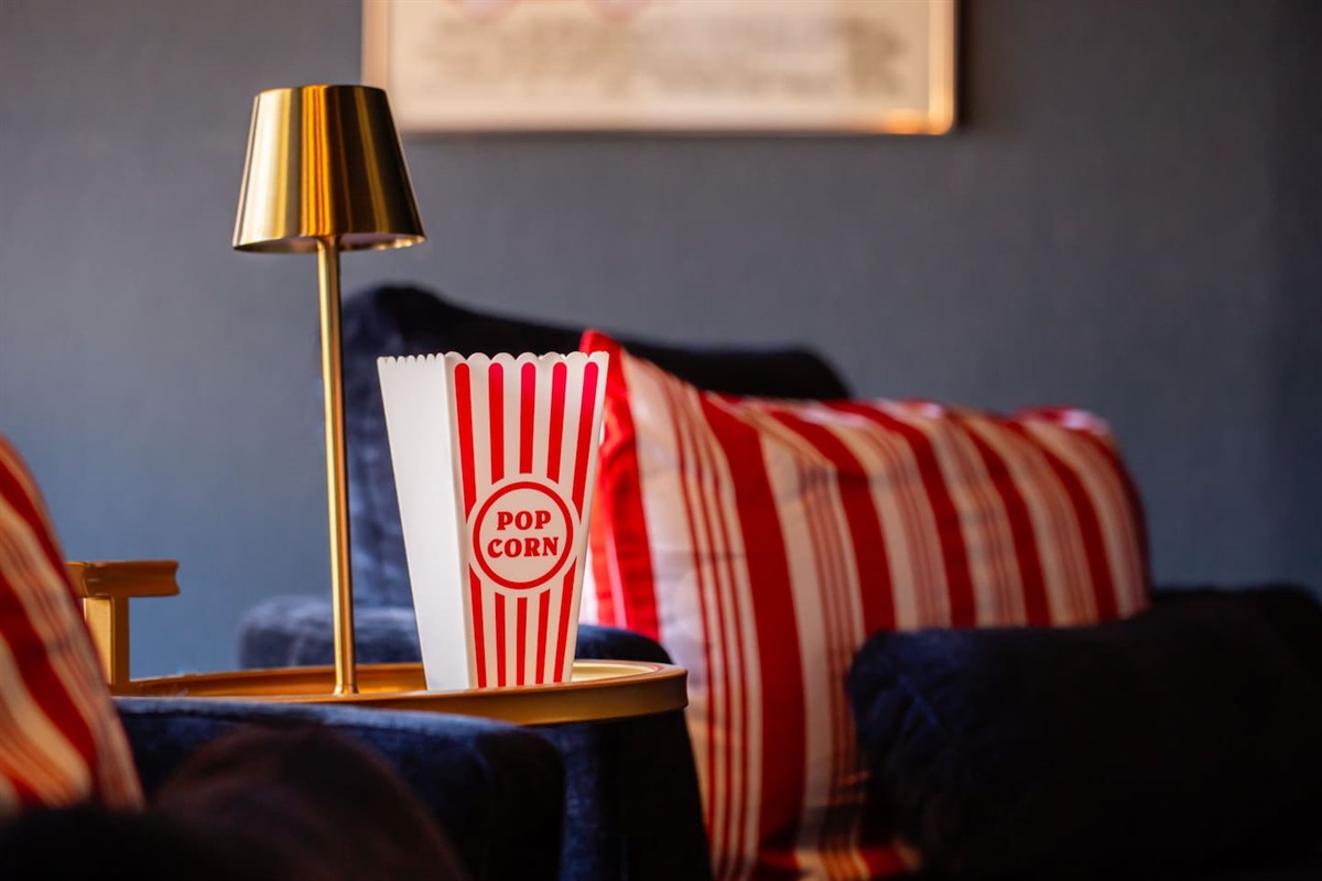 Enjoy a cozy movie night with popcorn in hand!  Relax in style with comfy seating and a vintage-inspired popcorn holder for the perfect touch. Perfect for your group's movie marathon or a fun-filled night of laughter and entertainment! 