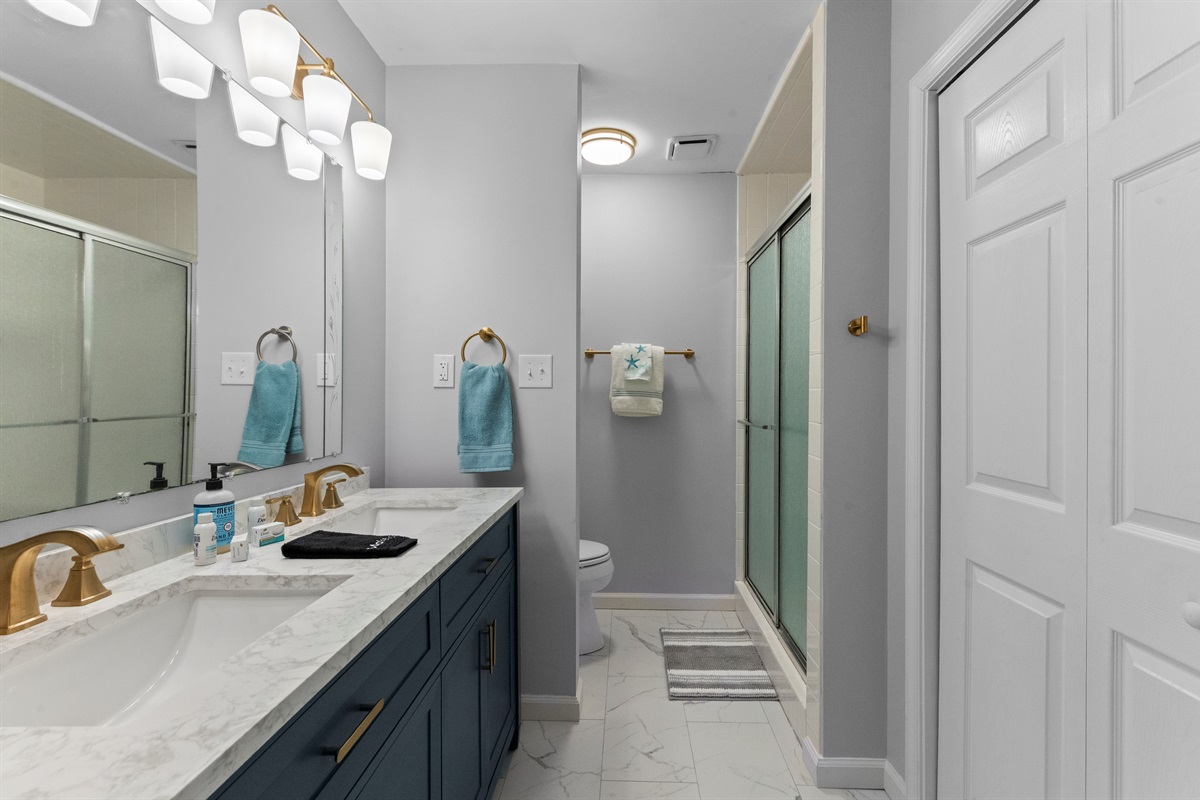 Bathroom: Elegant double sink vanity with luxe finishes and soothing coastal hues!