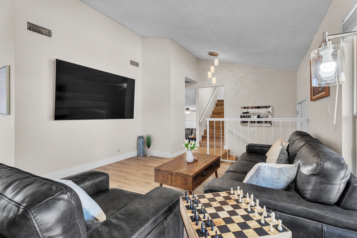 Living room 1 with 86 inch tv, simpsons arcade, bar table that converts to roulette and craps