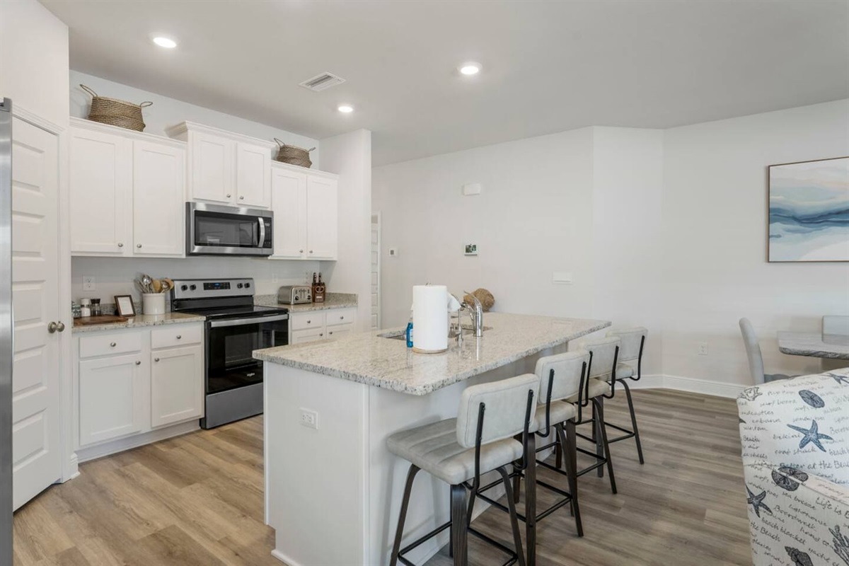 Entertain and cook in style with a full kitchen equipped with a breakfast bar and premium appliances.
