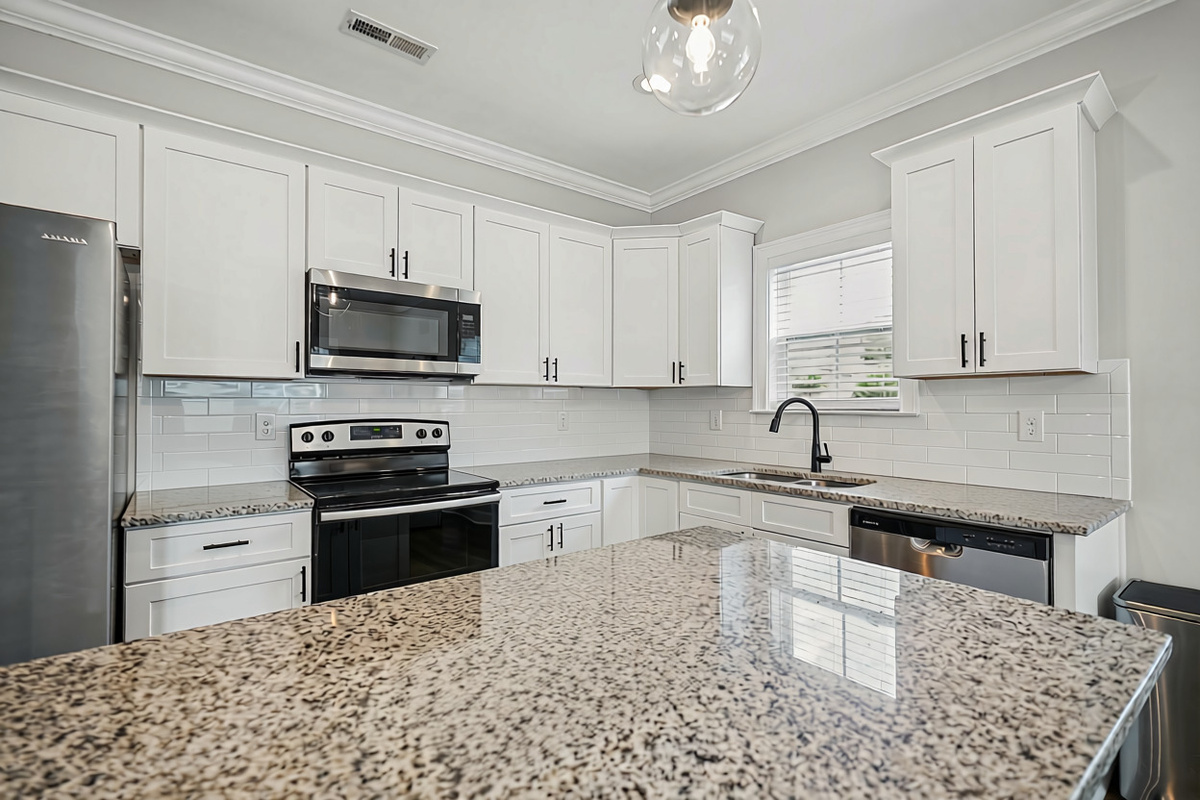 Spacious granite island countertop with plenty of room to prep and serve