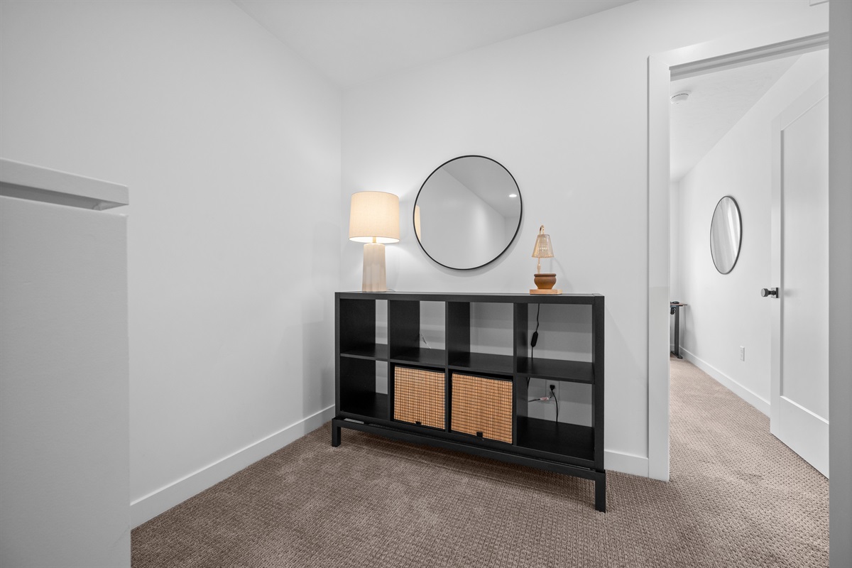 Upstairs hallway with clean design and storage space.