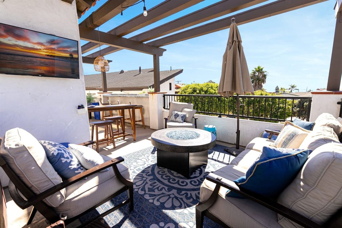 Fire pit and TV as seen from the hot tub.  Everyone can feel included.