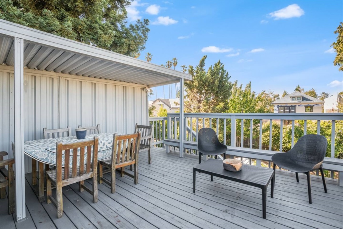 Outdoor patio eating area with a beautiful garden view.