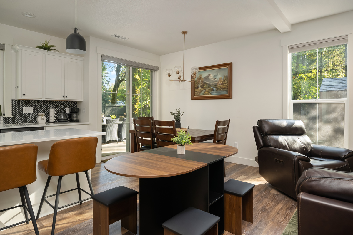 More room for everyone! The stylish console table transforms into a full dining table with chairs stored inside, making it easy to seat all 14 guests when both homes are booked.