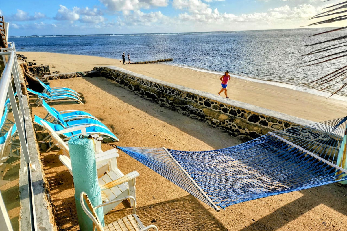 This picture was taken with a CELL PHONE! A centerpiece, true one-of-one feature of the home is the fact that it has its very own enclosed private beach with private steps leading to a crystal-clear,waist-deep turquoise-colored snorkeling coral reef