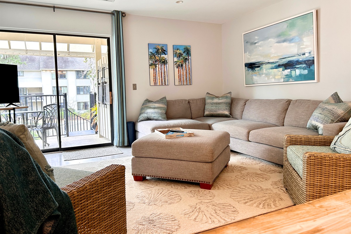 Updated living space with new rug and artwork, open concept