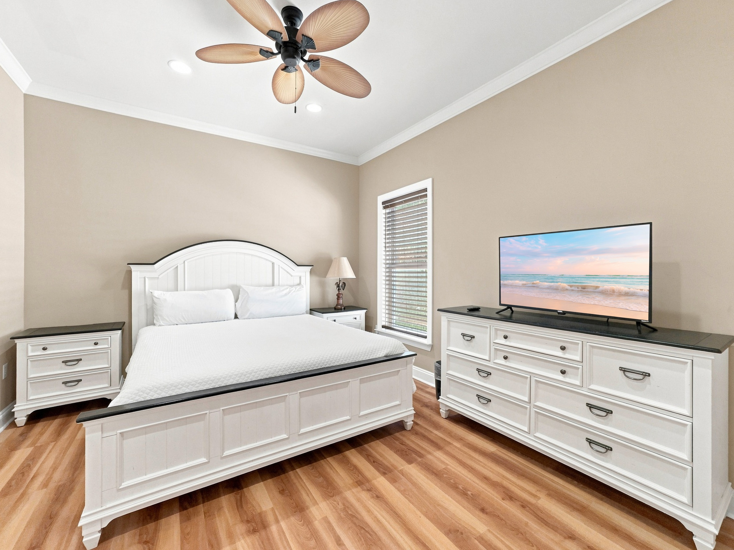 Bedroom with a smart TV and a water-view window