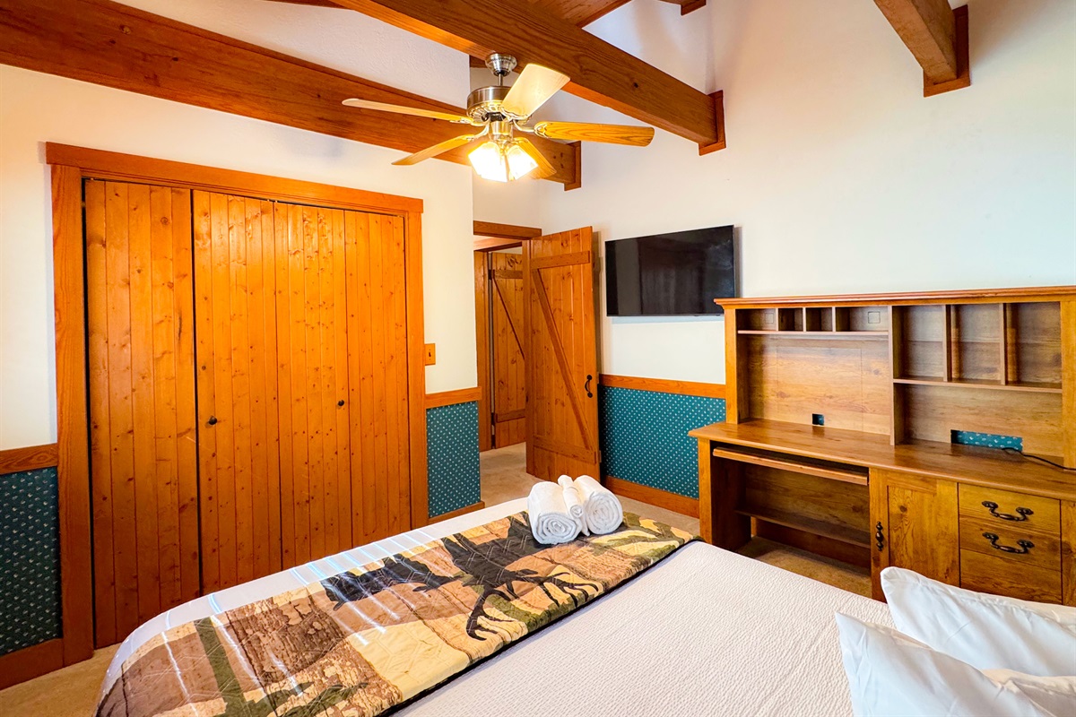 The upper level bedroom has a queen size bed and its own TV