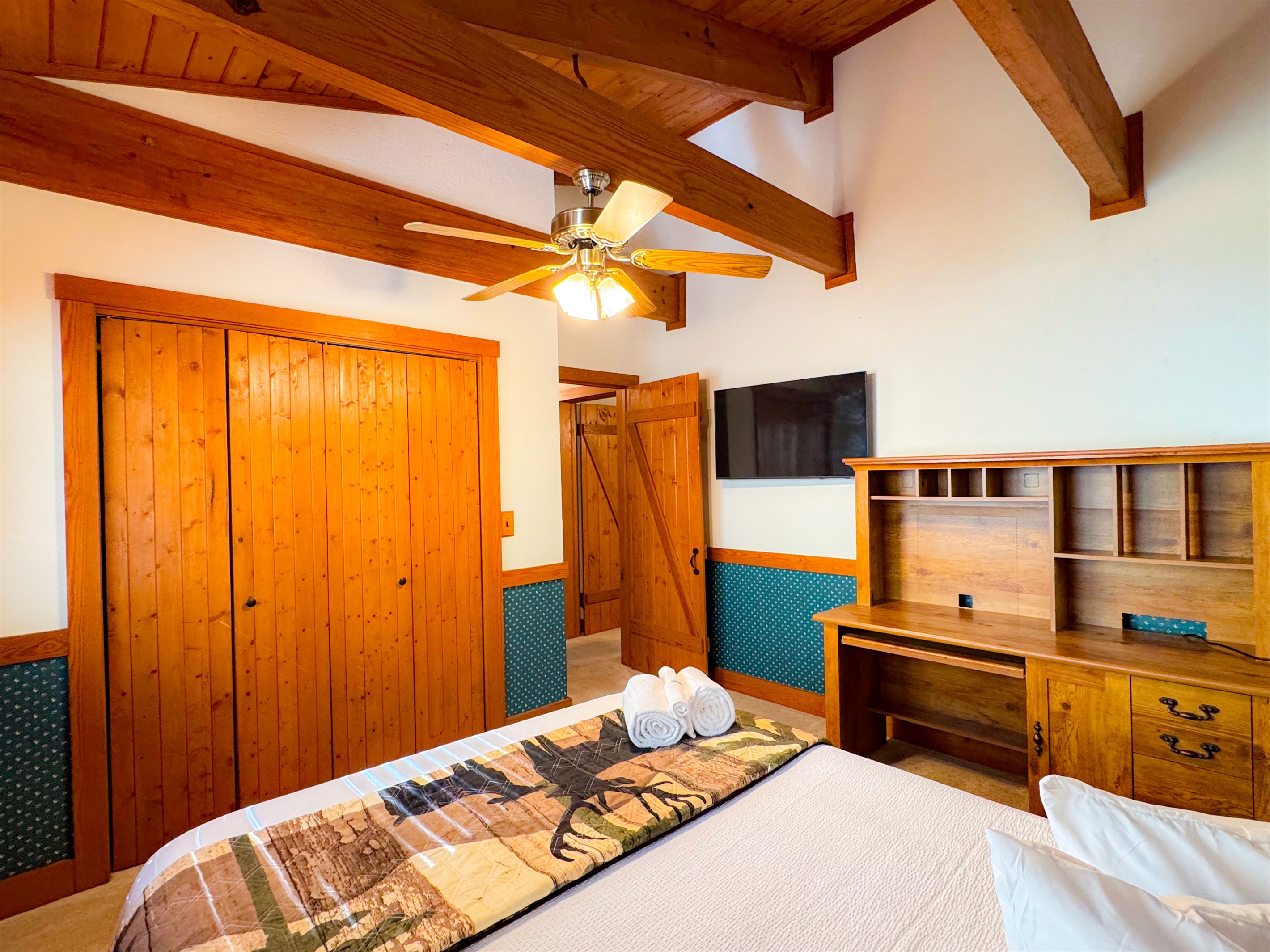 The upper level bedroom has a queen size bed and its own TV