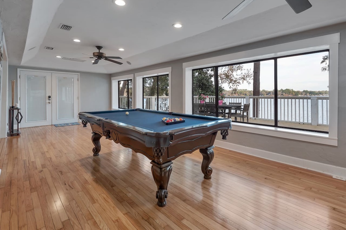 Pool table, lake view, stool seating, tv, deck and dock access