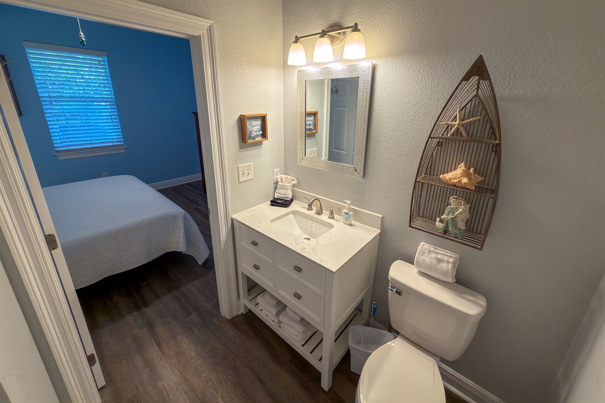 Bright modern finishes and direct bedroom access create a private bath designed for ease and everyday convenience.