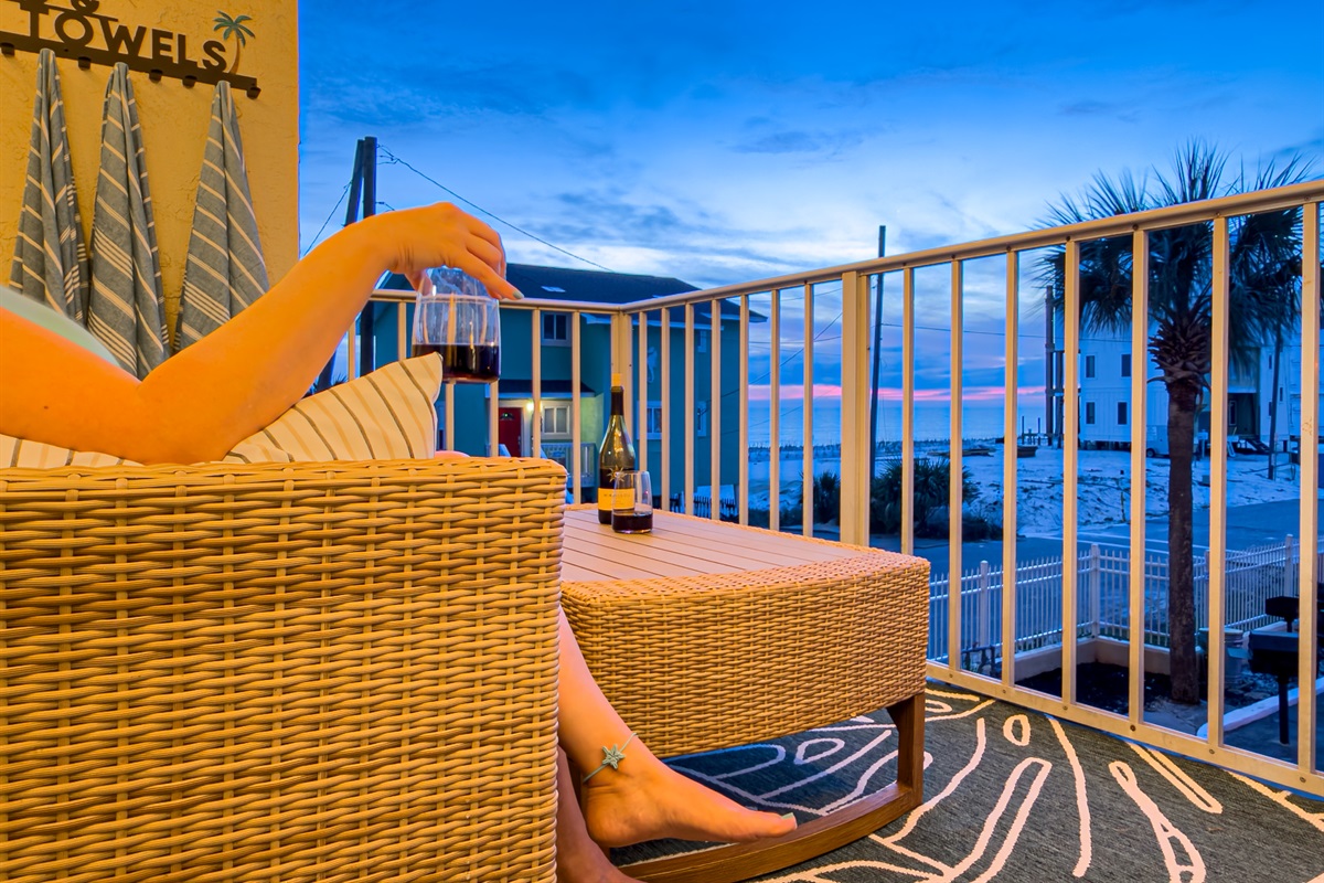You can hear the ocean from the deck while you enjoy a quiet evening. The overhead string lights create a cozy space for your evening drinks.