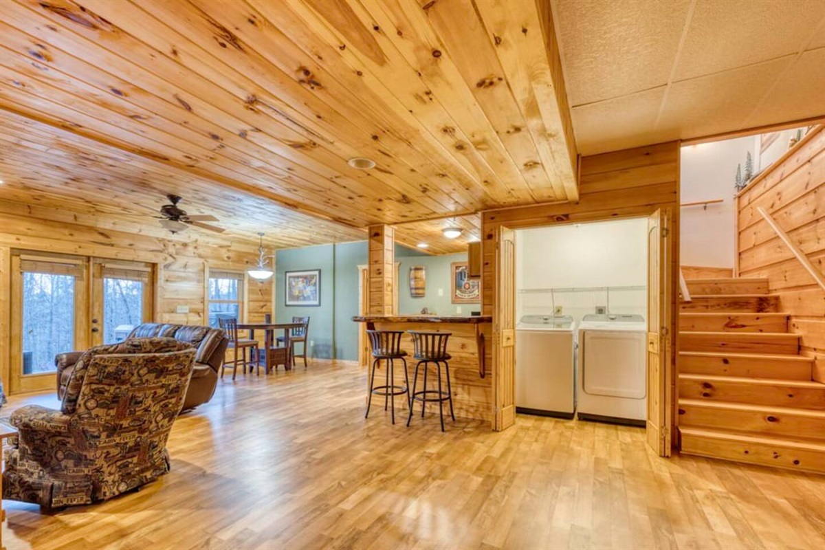 The washer and dryer are conveniently placed within the game room for easy access.