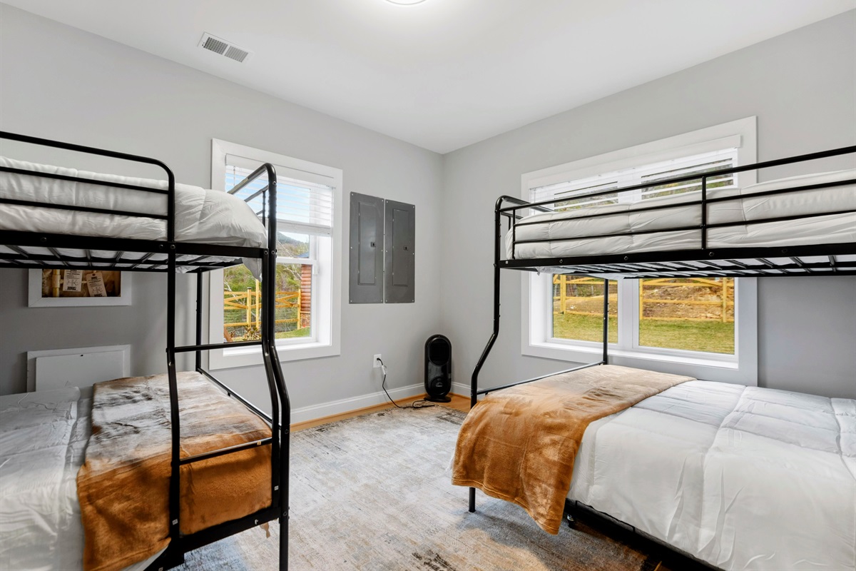 Sun-Kissed Serenity – Wake up to golden morning light and fresh mountain air in this thoughtfully designed bunk room, offering space, comfort, and connection to the outdoors.