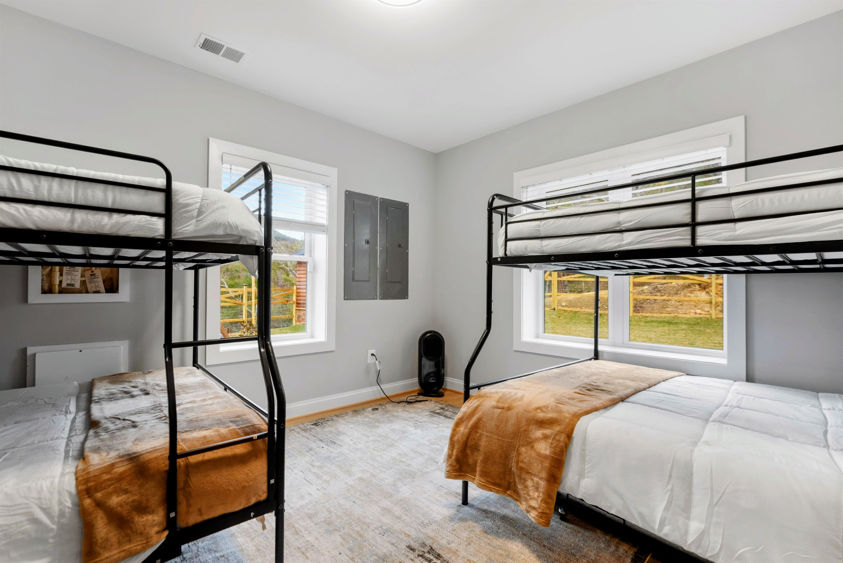 Sun-Kissed Serenity – Wake up to golden morning light and fresh mountain air in this thoughtfully designed bunk room, offering space, comfort, and connection to the outdoors.