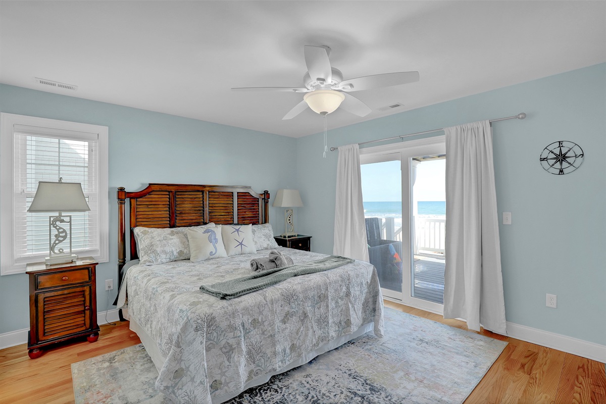 Wake up to the waves in this spacious king bedroom with private deck access.