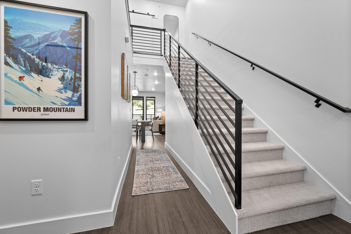 Stairway leading to the spacious upper-level family suite.