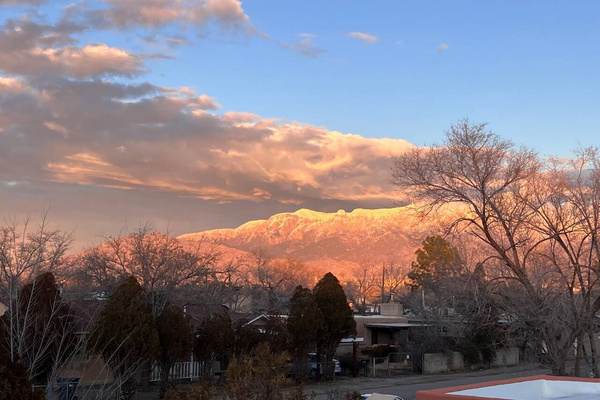 The 10,300 ft Sandia Mountains from our winter window. In Spanish, Sandia means “watermelon”. Can you see why? 