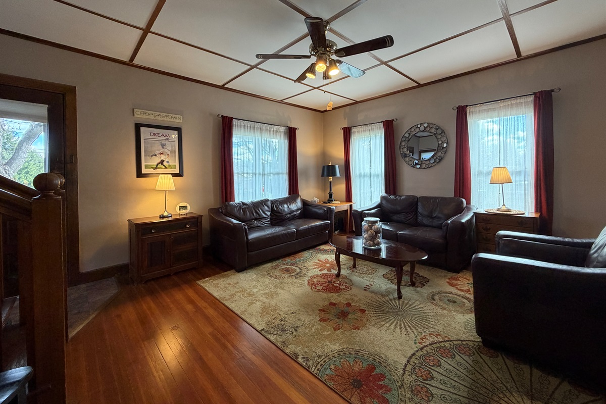 Living room with leather lounging furniture and a smart TV.