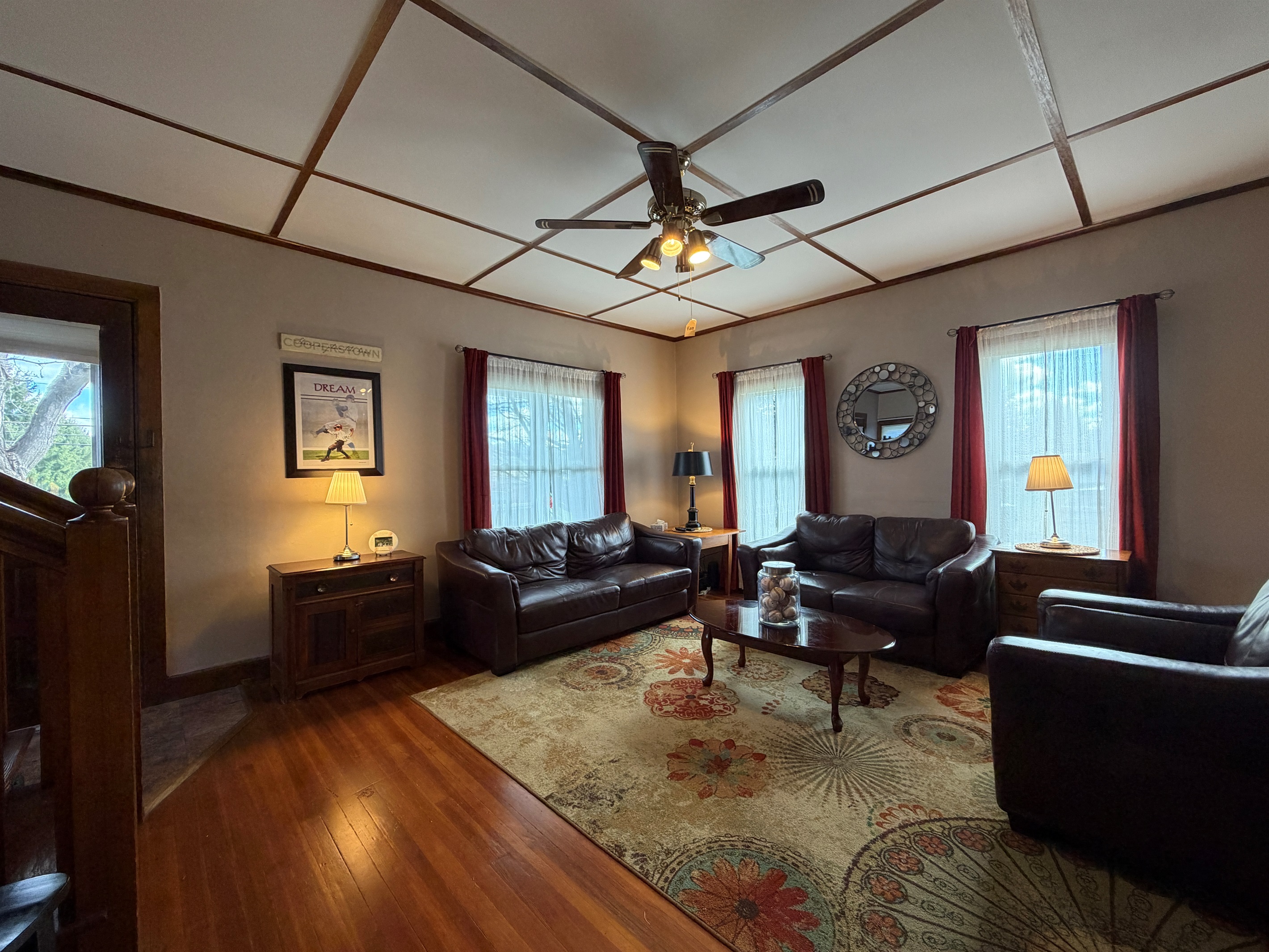 Living room with leather lounging furniture and a smart TV.
