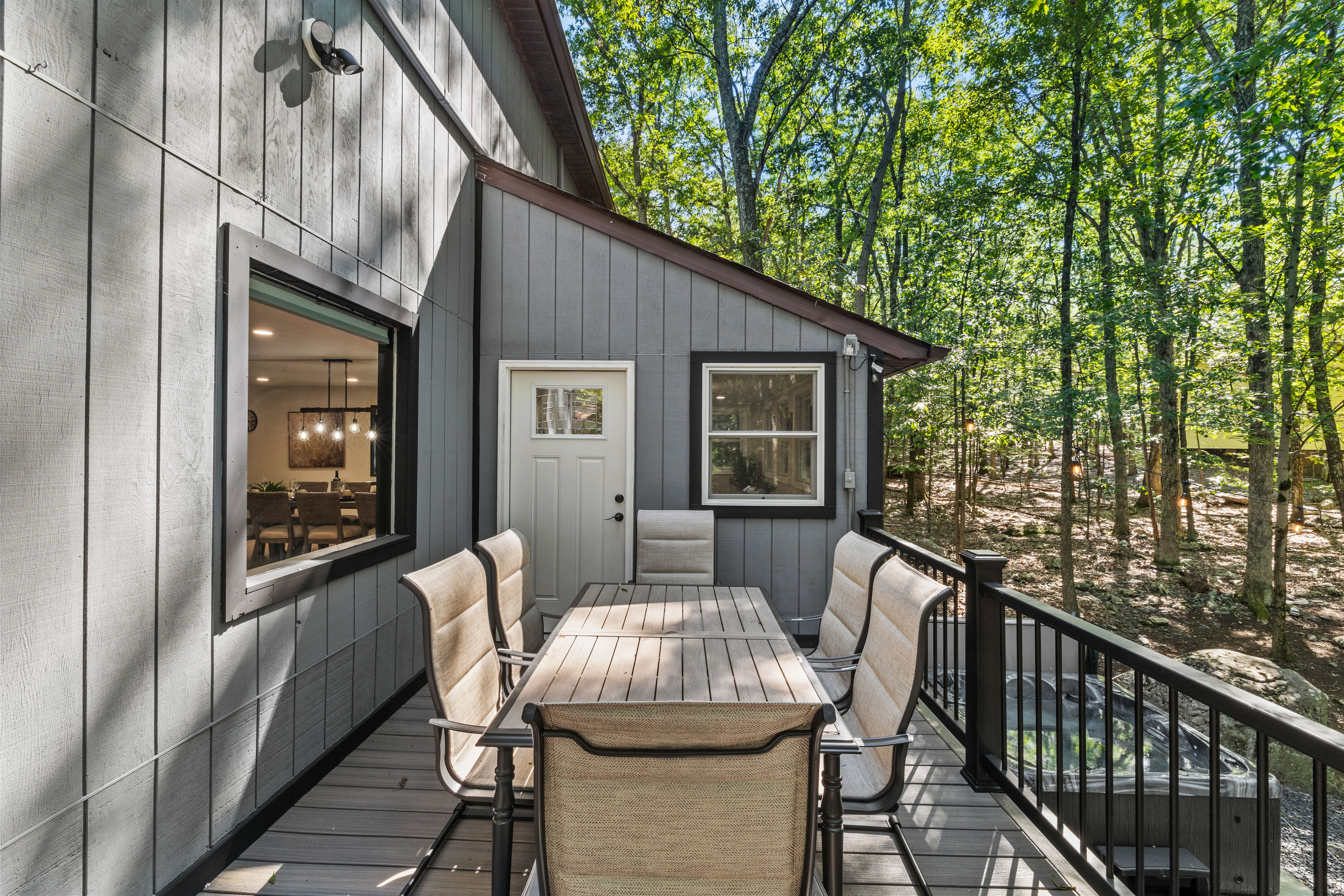 Tabletop space surrounded by matching high-back chairs to comfortably host large family meals outdoors.