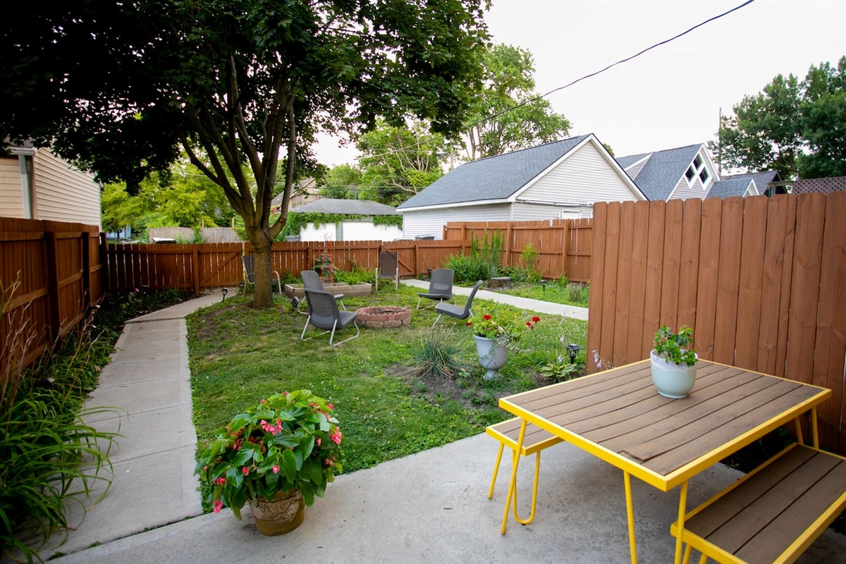 Shared fenced backyard with fire pit and private garden patio - a cozy spot for relaxed evenings under the stars. 
