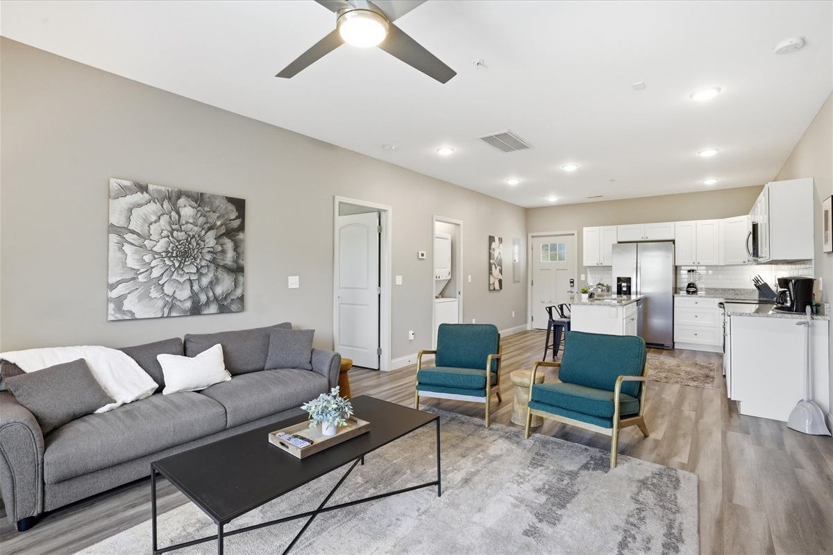 From this angle in Unit 1, you can see how it all connects—kitchen, seating, and a space that keeps everyone in the mix, whether you’re watching something or just hanging out.
