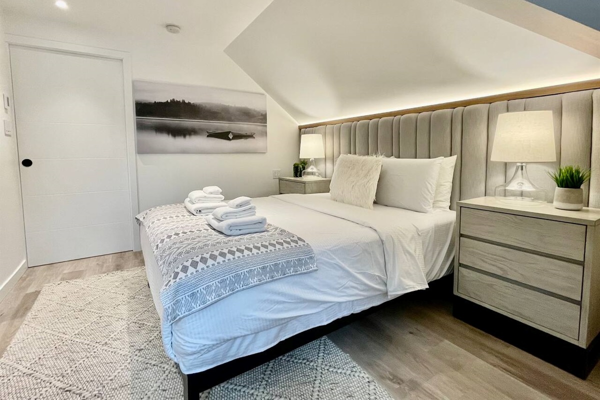 Master bedroom #1 features built in wall to wall upholstered headboard with built-in accent lights 