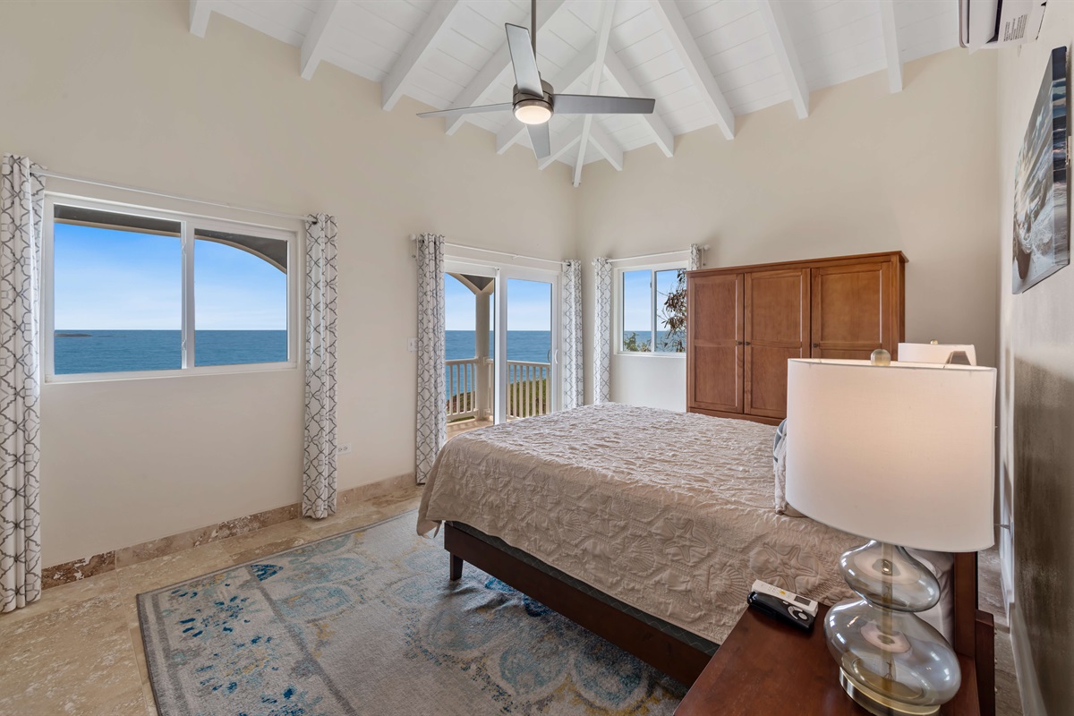 Another angle of the queen bedroom showcasing natural light and space.