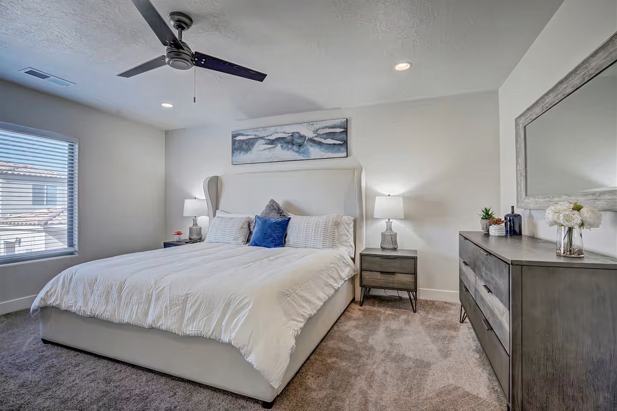 Luxurious California King bed in master bedroom.