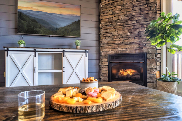 Enjoy breathtaking mountain views from the cozy, spacious living room, beautifully designed with modern amenities and classic cabin touches. Furnished with a 65" Smart TV, 2 big comfy sofas, a fireplace.