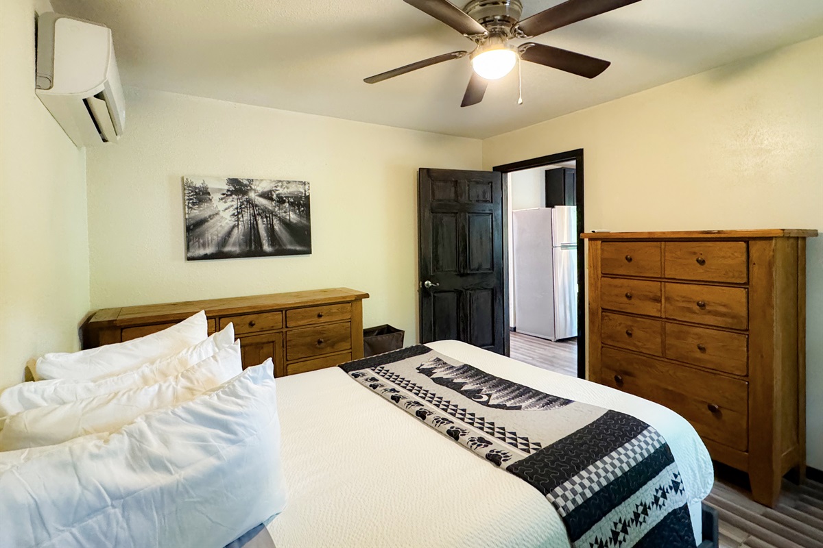 The apartment bedroom has a queen size bed, its own living space and bathroom