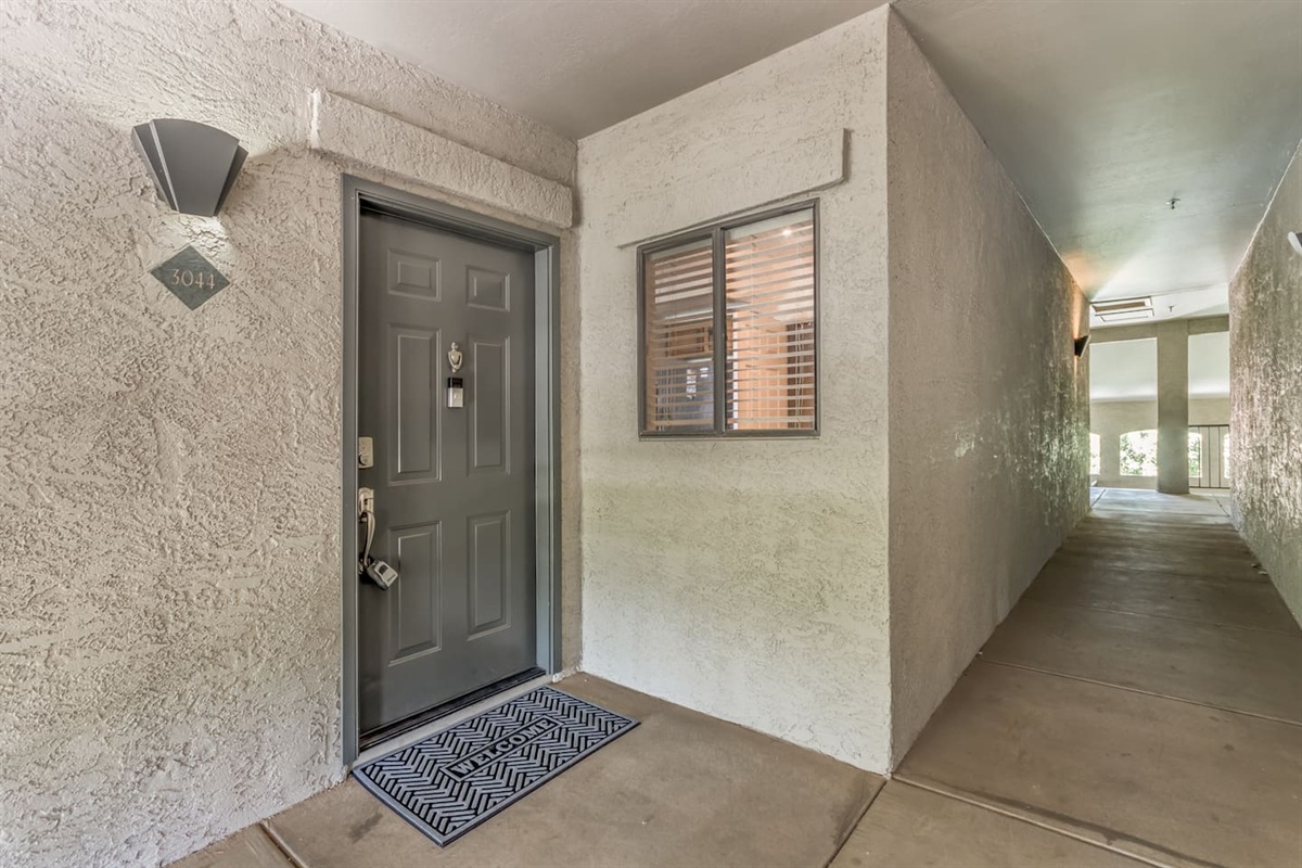 Front door entry with covered corridor access for a simple arrival setup.