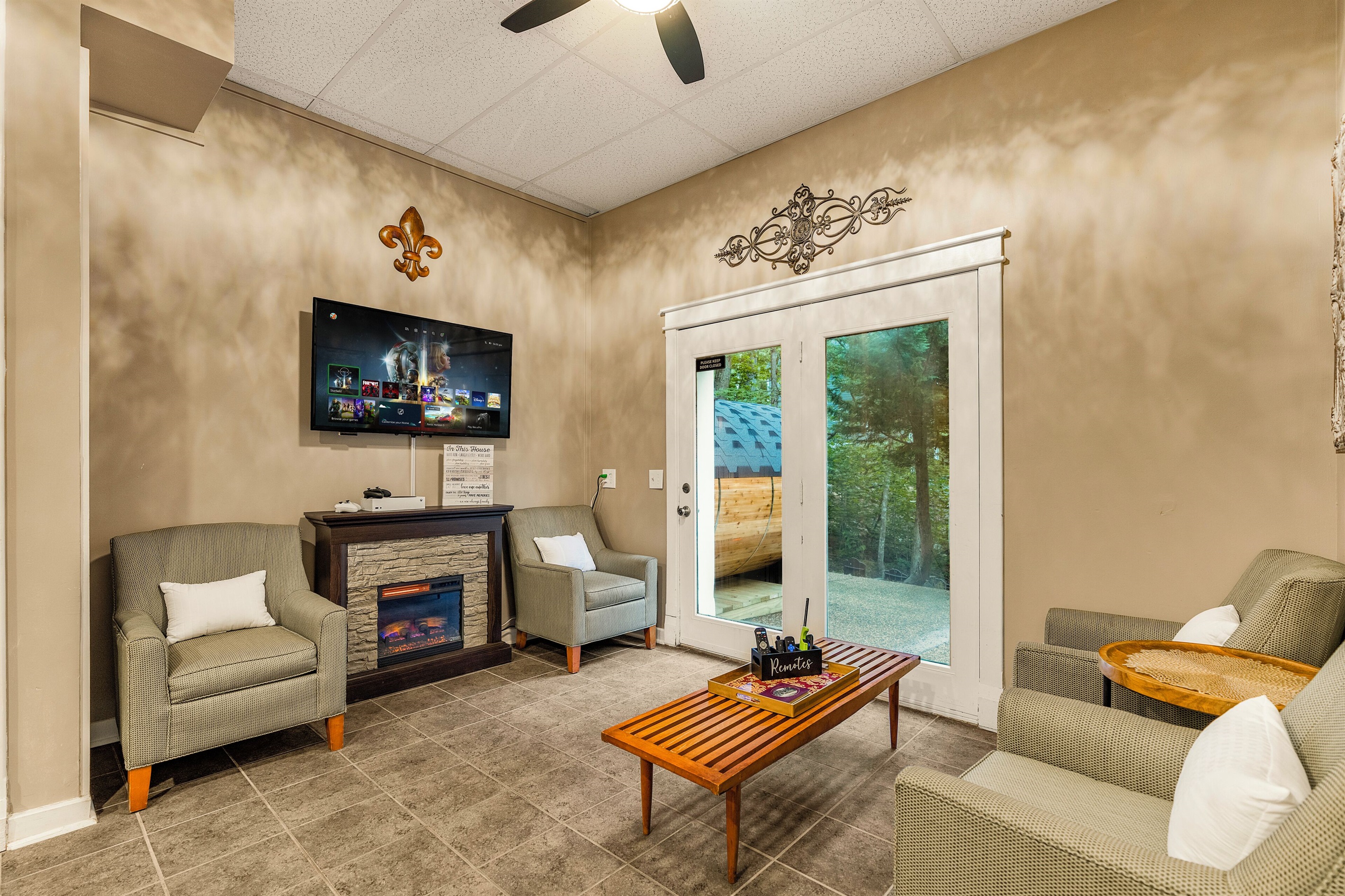 Lounge area with card table and TV with Xbox Series S
