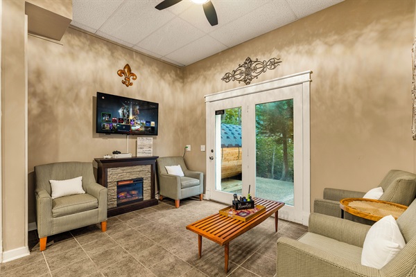 Lounge area with card table and TV with Xbox Series S
