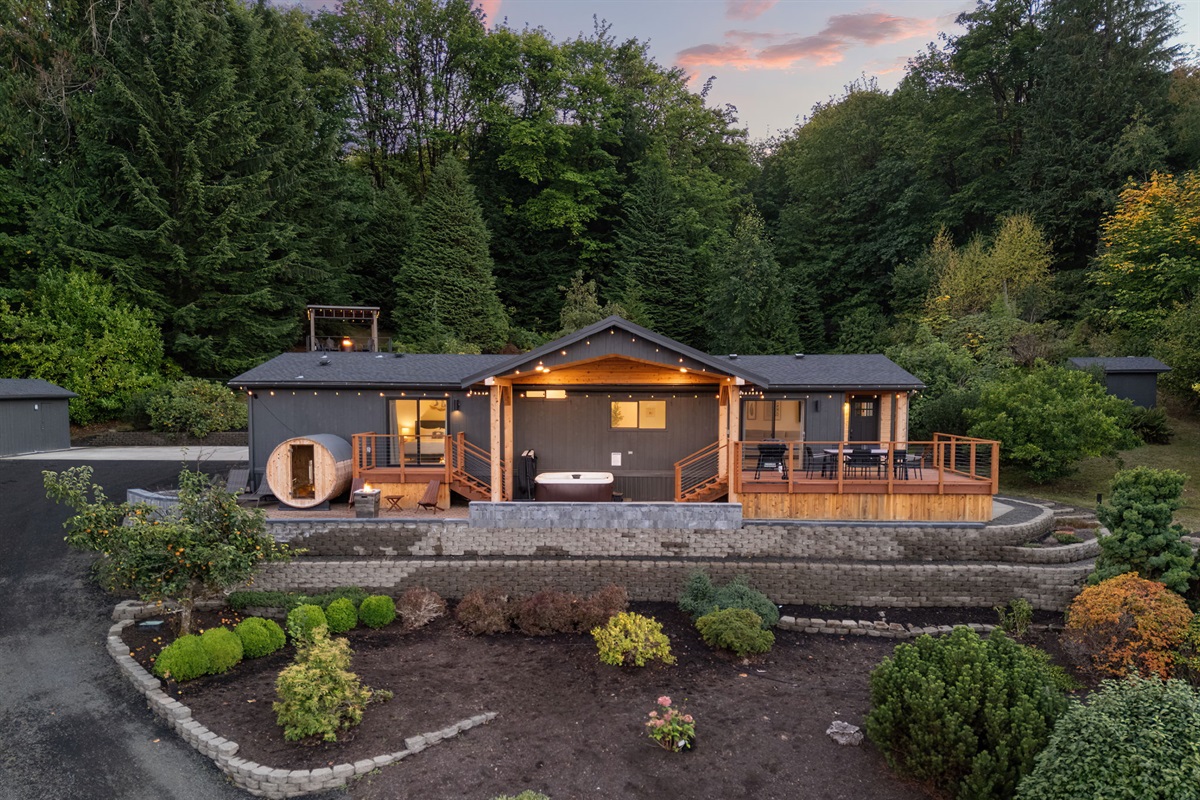 The home glows warmly against the evening sky—a welcoming retreat to unwind and relax
