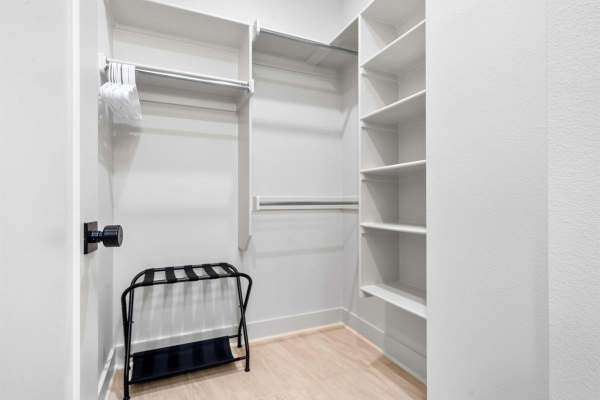 This spacious walk-in closet has room for all your essentials, adding convenience and making it easy to stay organized.