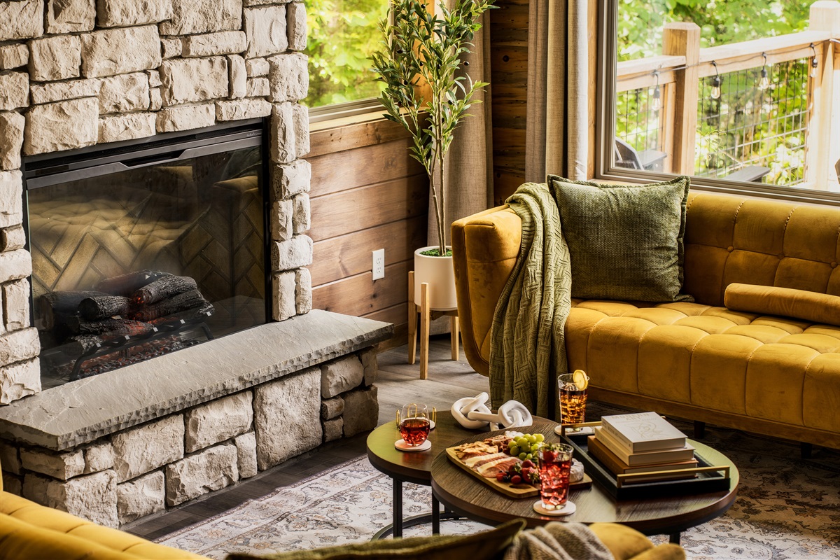 Stylish living room with plush seating & electric fireplace, perfect for family time