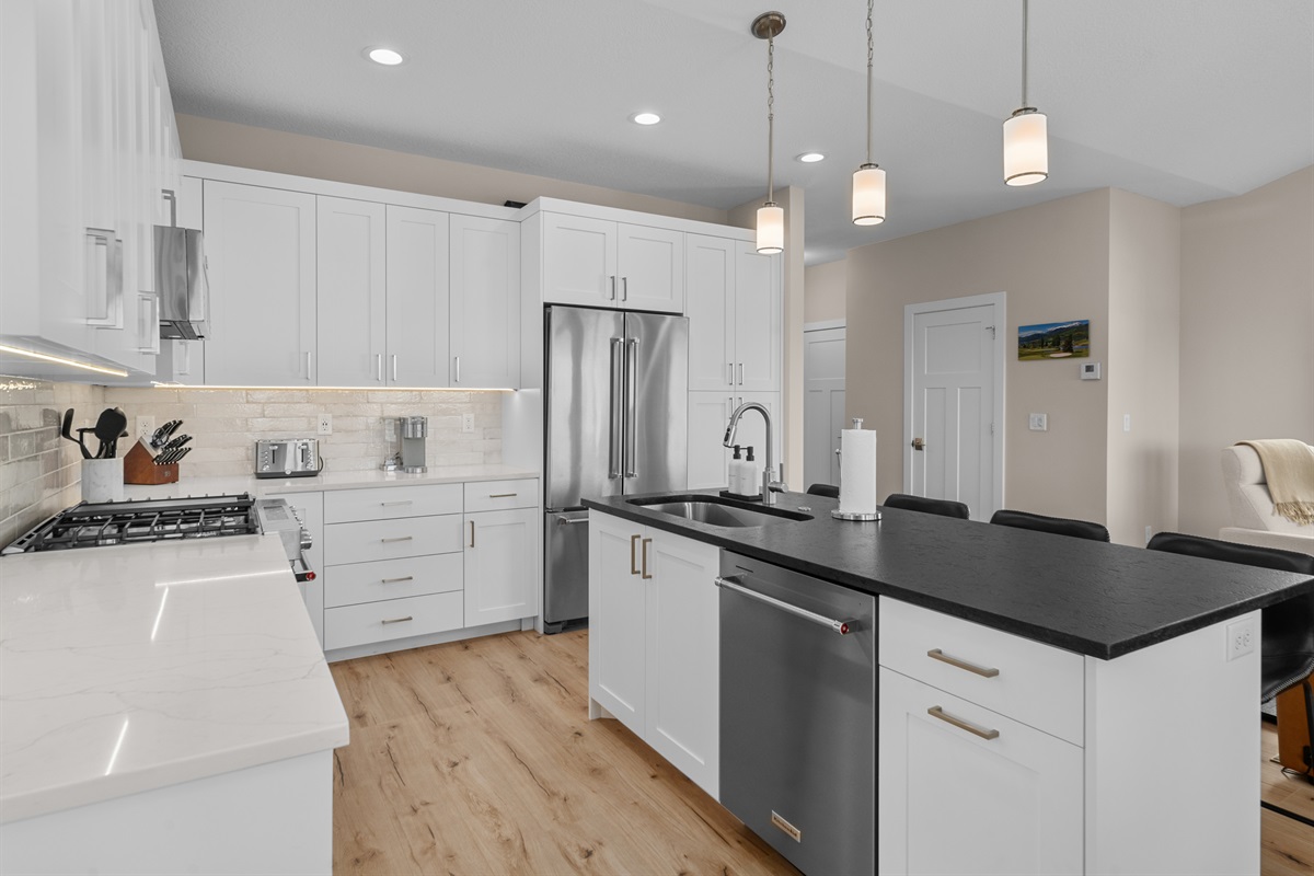 Fully equipped kitchen with stainless appliances and sleek finishes.