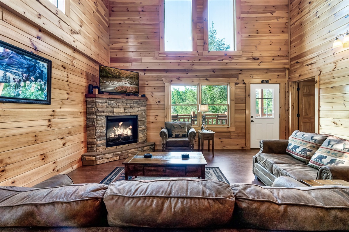 Relax together in the light filled living room where vaulted ceilings, warm wood, and mountain charm set the tone.