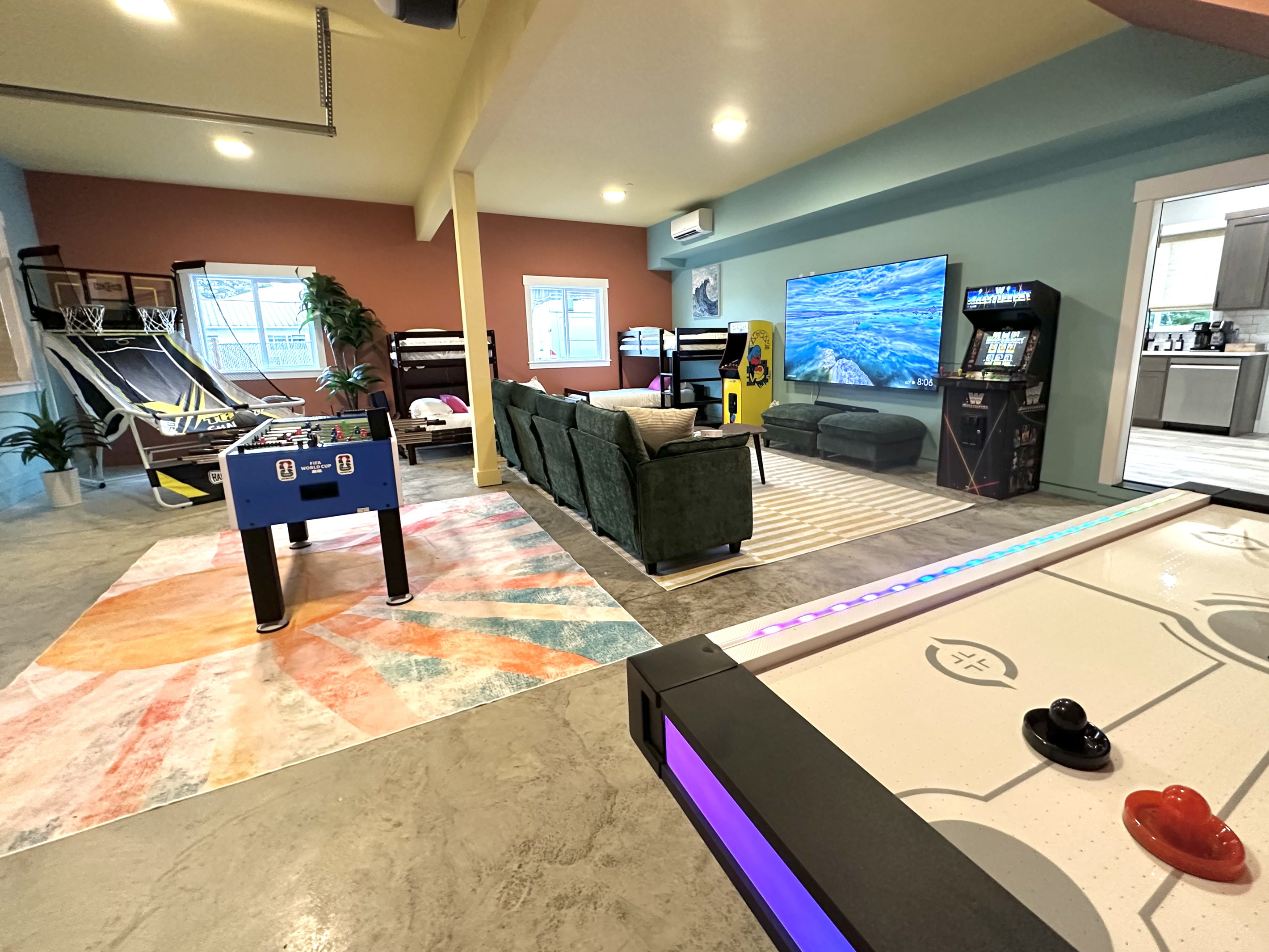 Foosball, air hockey and classic arcade cabinets fill the far end of the lower level — the tournament starts as soon as you drop your bags.