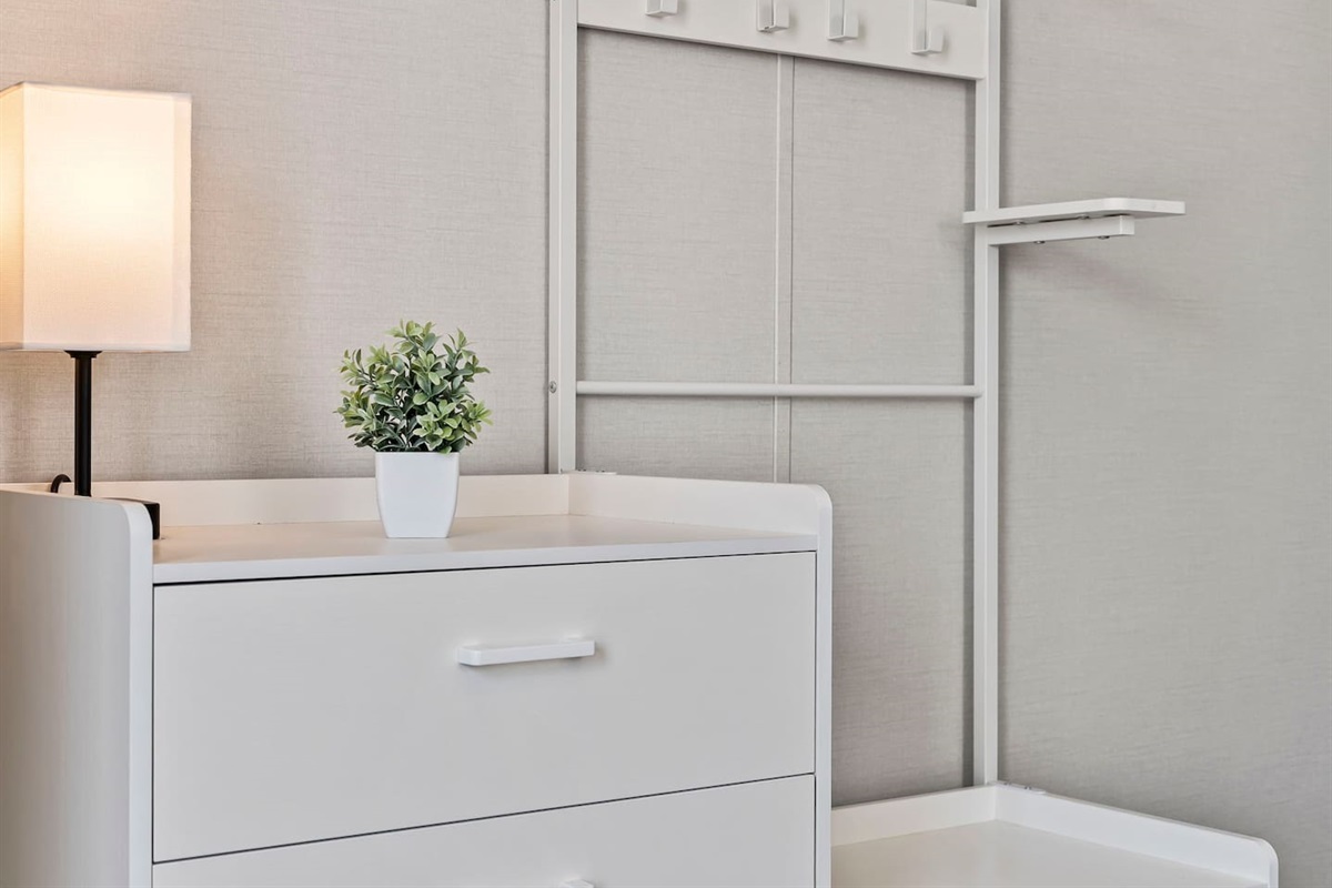 Clean dresser and storage area with modern touches—ideal for organizing your stay.