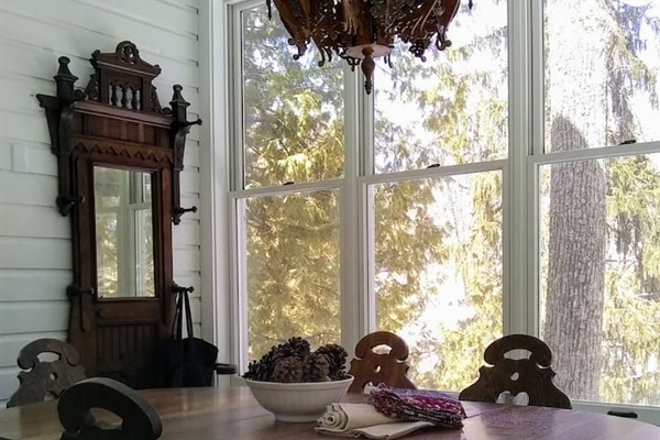 The dining porch is a lovely gathering place for the whole group.